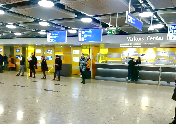 drivers waiting in line for their clients with name boards in front of the Visitors Center in the arrivals hall at the Geneva Airport